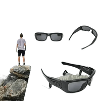 Side view of black camcorder sunglasses featuring built-in camera and attached headphones.