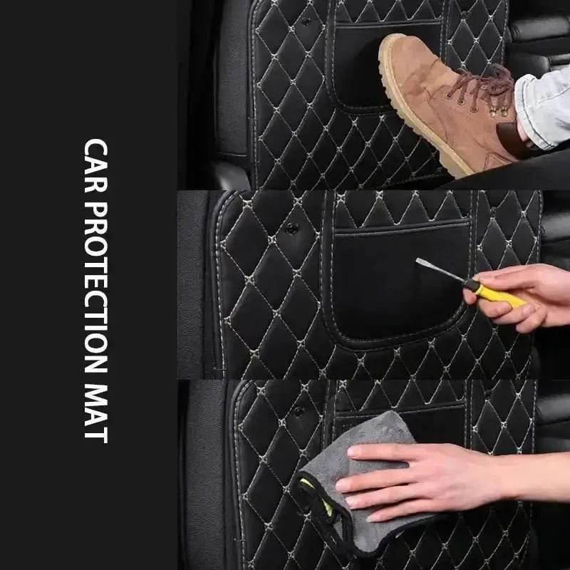 Detail shot of textured black car seat protector pad with red stitching against car interior backdrop.