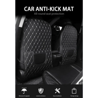 Top view of black car seat protector pad with red stitching fitted on car seat shielding fabric.