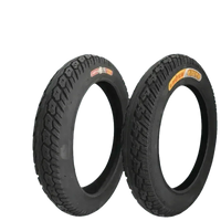 Two black CST electric bike fat tires standing upright on a white background.