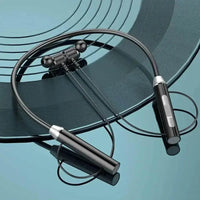 Black magnetic wireless earphones with neckband laid out on a white surface.