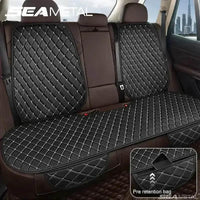 Black quilted leather car seat cover installed on a vehicle seat, showing smooth texture and stitching.