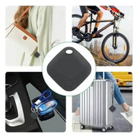 The black square Bluetooth tracker next to a smartphone displaying a tracking app.