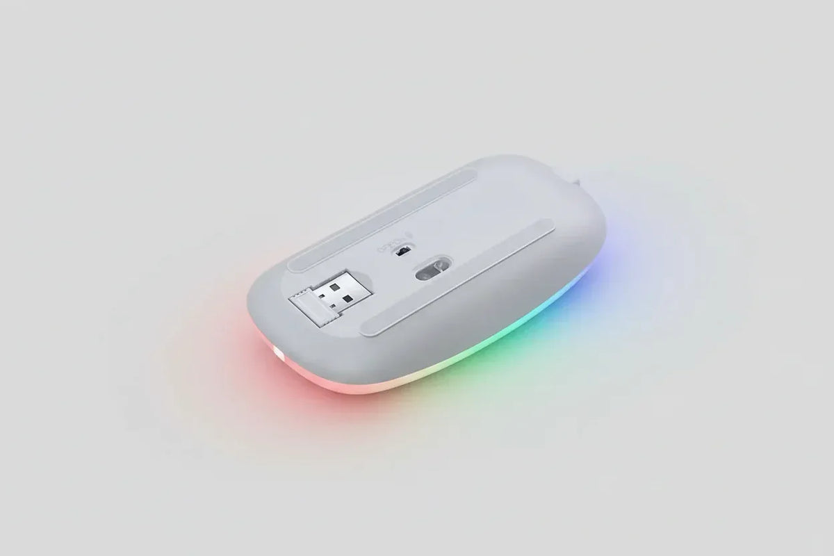 USB rechargeable RGB LED wireless mouse on desk with keyboard and computer.