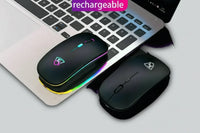Black USB rechargeable RGB LED wireless mouse next to keyboard and two coffee cups.