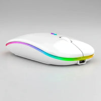 Black USB rechargeable RGB LED wireless mouse beside white keyboard on wooden desk.