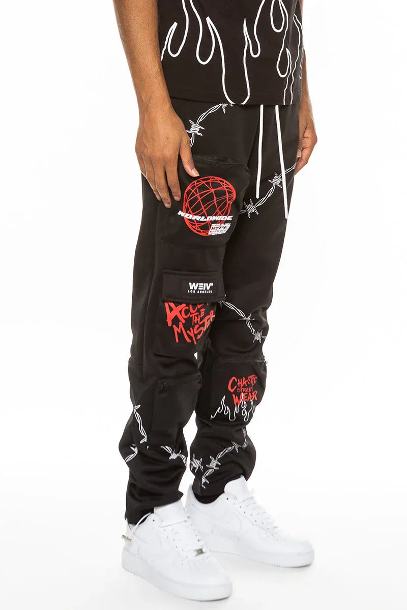 Side view of black men's track pants highlighting elastic waistband and zippered pouch pockets
