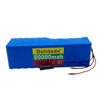 Blue scooter battery pack with wires and connectors visible on white surface.