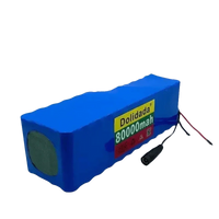 Close-up of blue 24V 80Ah scooter battery pack showing attached connector.