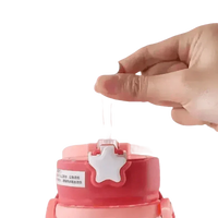 Child holding blue dinosaur antler water sippy cup outdoors, designed for easy drinking