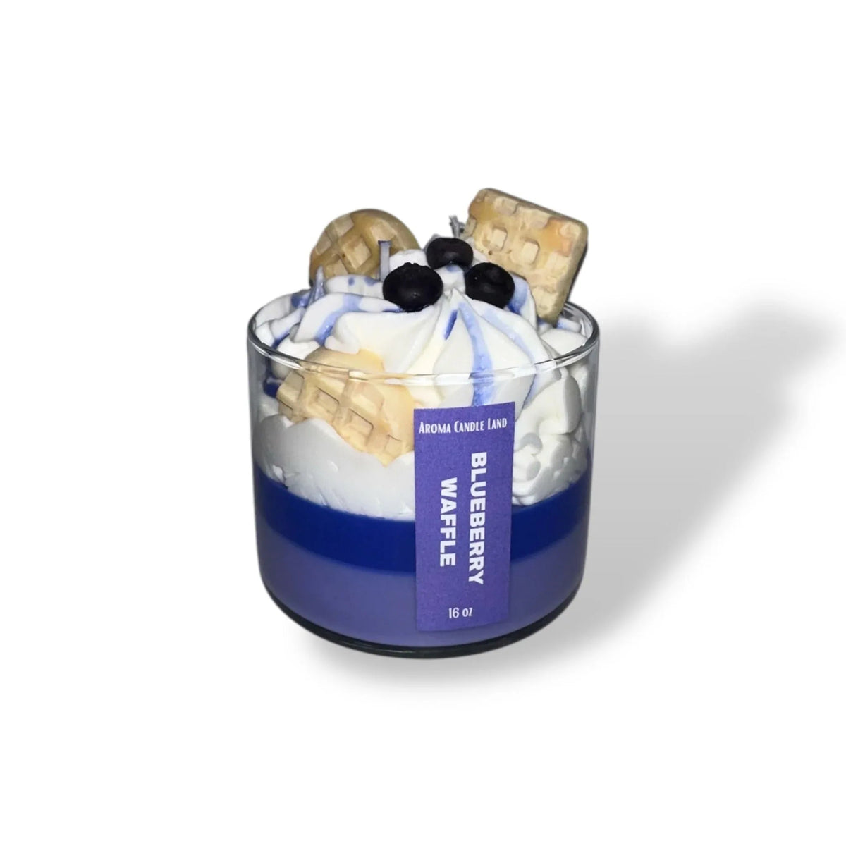 Close-up of a Blueberry Waffle Decorative Candle shaped like a breakfast waffle topped with blueberries.