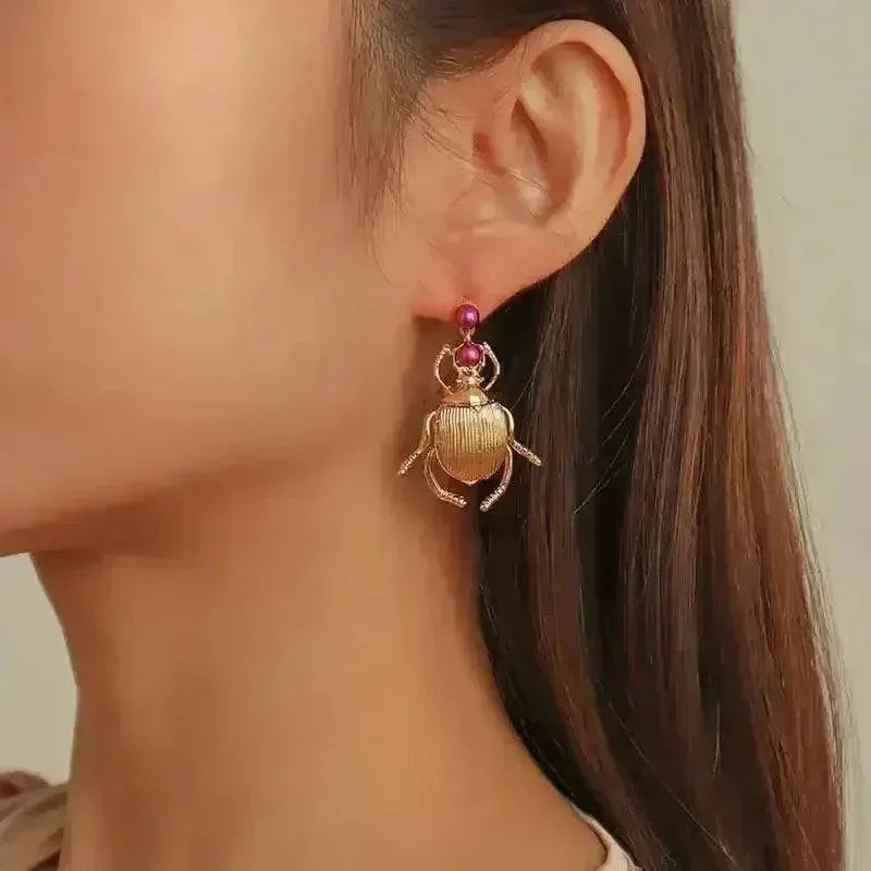 Front view of vintage style beetle-shaped gold-plated Bohemia earrings with intricate details.