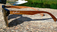Side profile of walnut wood sunglasses displaying smooth temple and lens curvature.