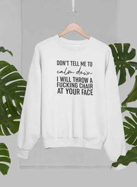 Grey crewneck sweatshirt displayed on a hanger with palm tree backdrop