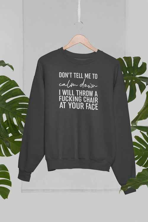 Front view of grey crewneck sweatshirt displayed against palm trees