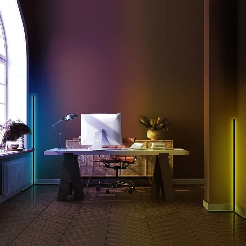 RGB LED corner floor lamp standing on wooden floor showing color variations and remote control.