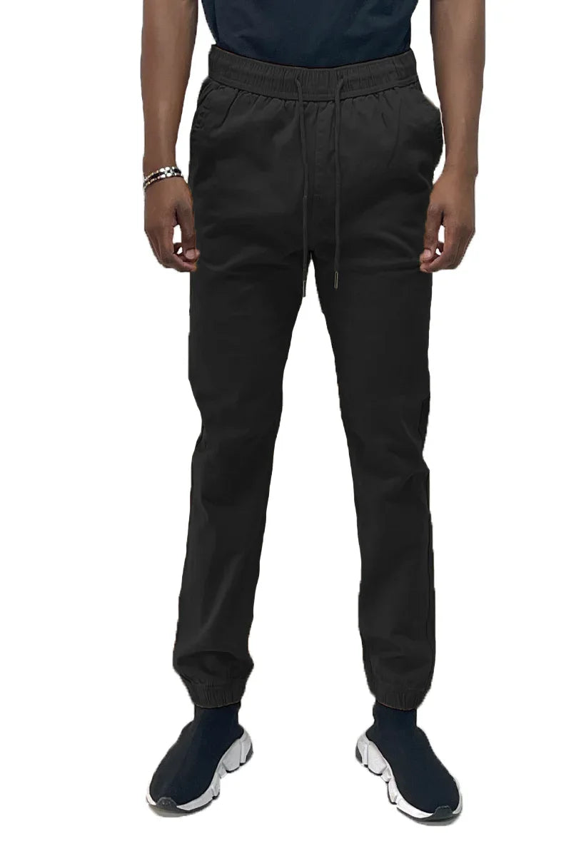 Front view of black solid jogger pants featuring elastic waistband and standard pockets.