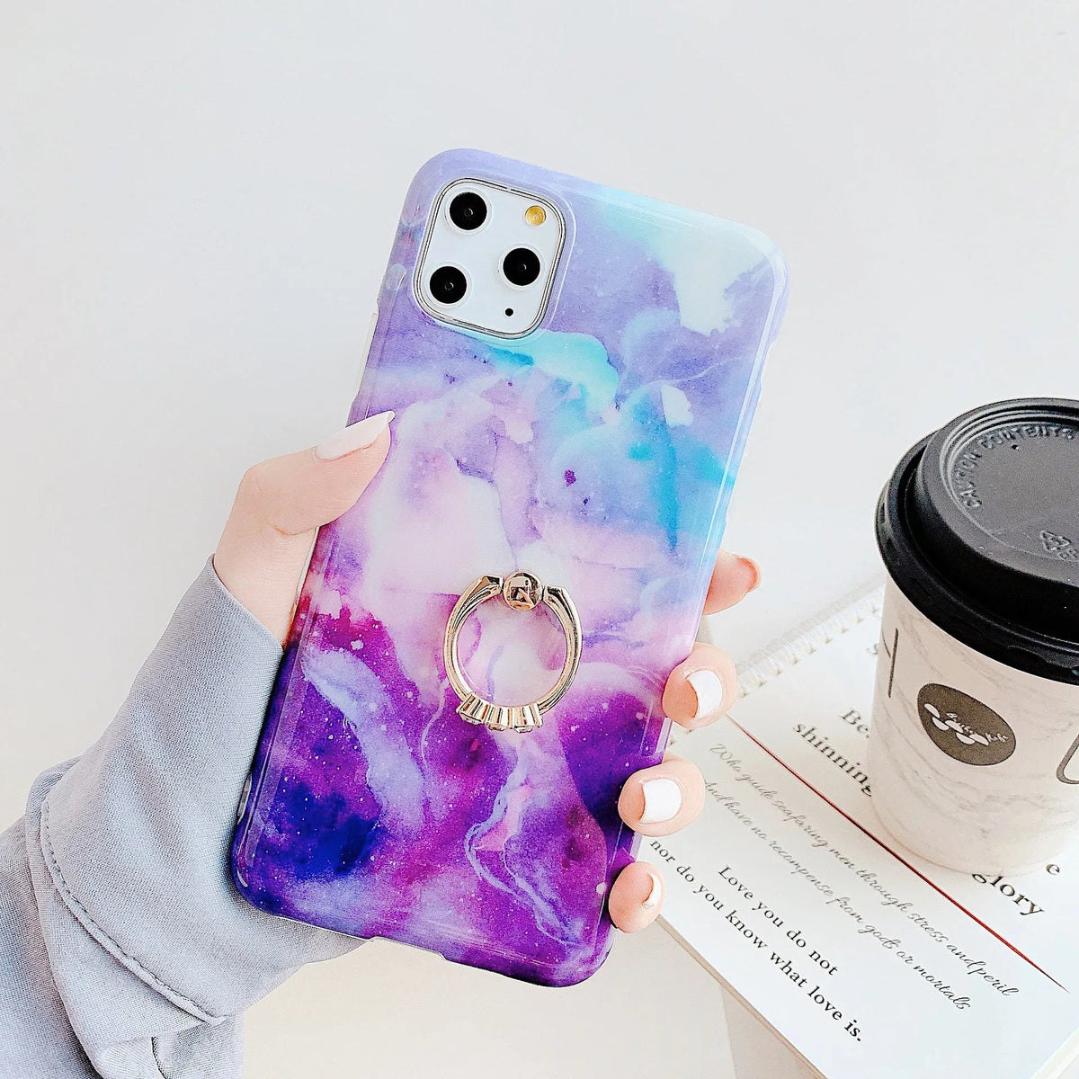Marble iPhone case easily removable, showing flexible soft rubber material.