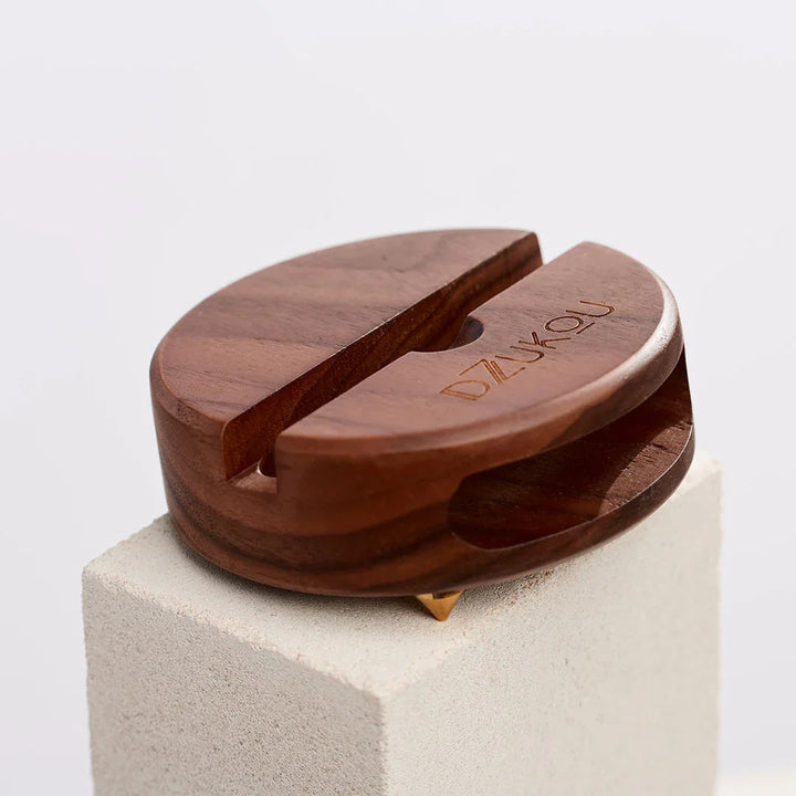 Walnut Squirrel wooden phone stand and sound amplifier made from bamboo, shown holding a smartphone.