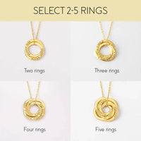 Detailed view of interlocking silver rings necklace showing smooth surfaces and engraved family names.