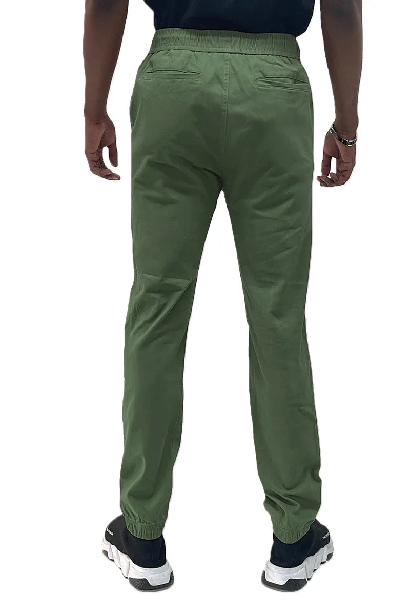 Close-up detail of jogger pants fabric texture and elastic waistband with slight stretch.