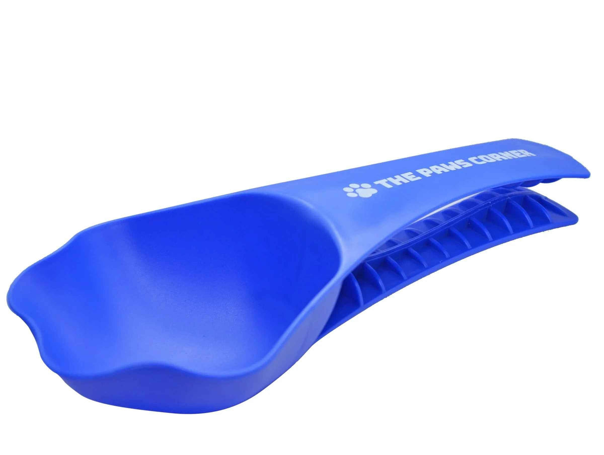 Paw-shaped pet food scoop with a clip, holding one cup of kibble, shown beside a dry pet food bag.