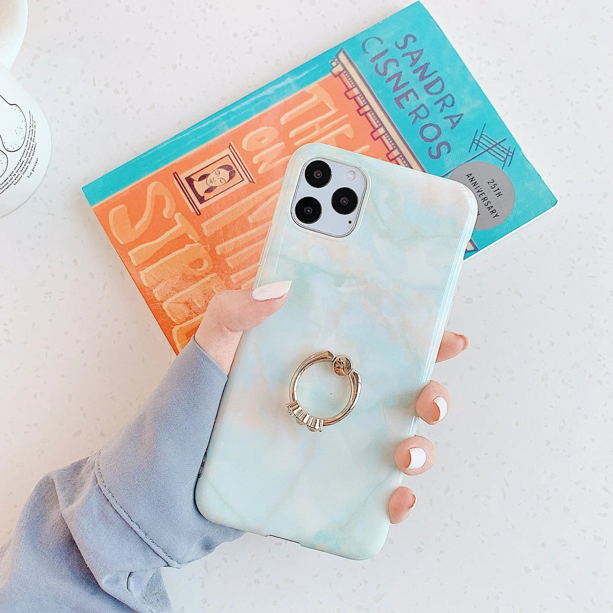 Marble pattern on iPhone case wrapping fully around edges for 360-degree protection.