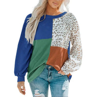 Side view of woman wearing leopard patchwork color block ribbed long sleeve top paired with jeans.