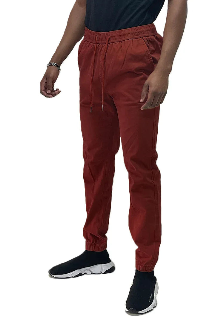 Front view of solid jogger pants with elastic waistband and standard pockets on a plain background.