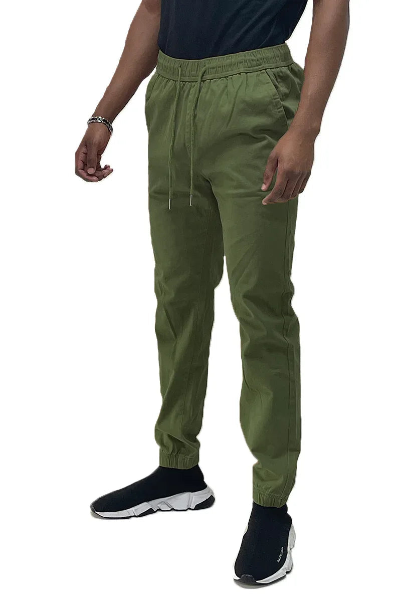 Front view of solid color jogger pants with elastic waistband and standard pockets on a plain background.