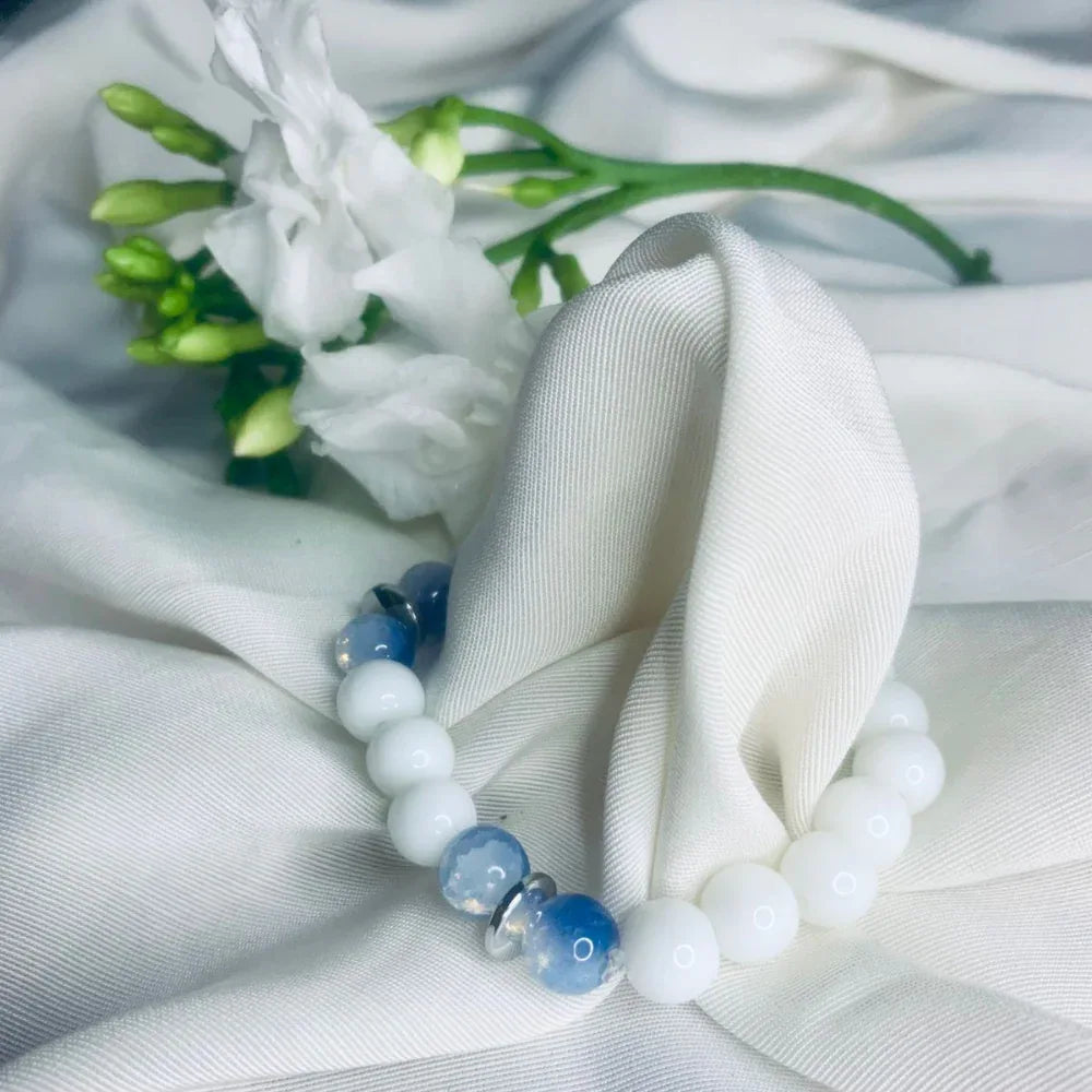 Elegant stretch bracelet with calming blue lace agate and white howlite beads accented by silver.