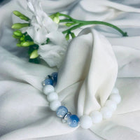 Elegant stretch bracelet with calming blue lace agate and white howlite beads accented by silver.