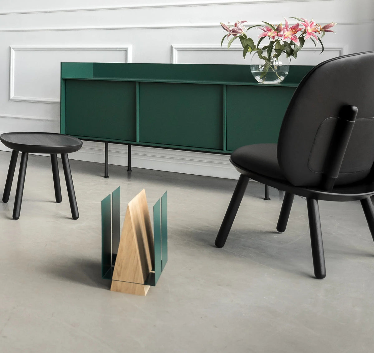 WINGS magazine rack on hardwood floor holding various magazines, illustrating its compact size.