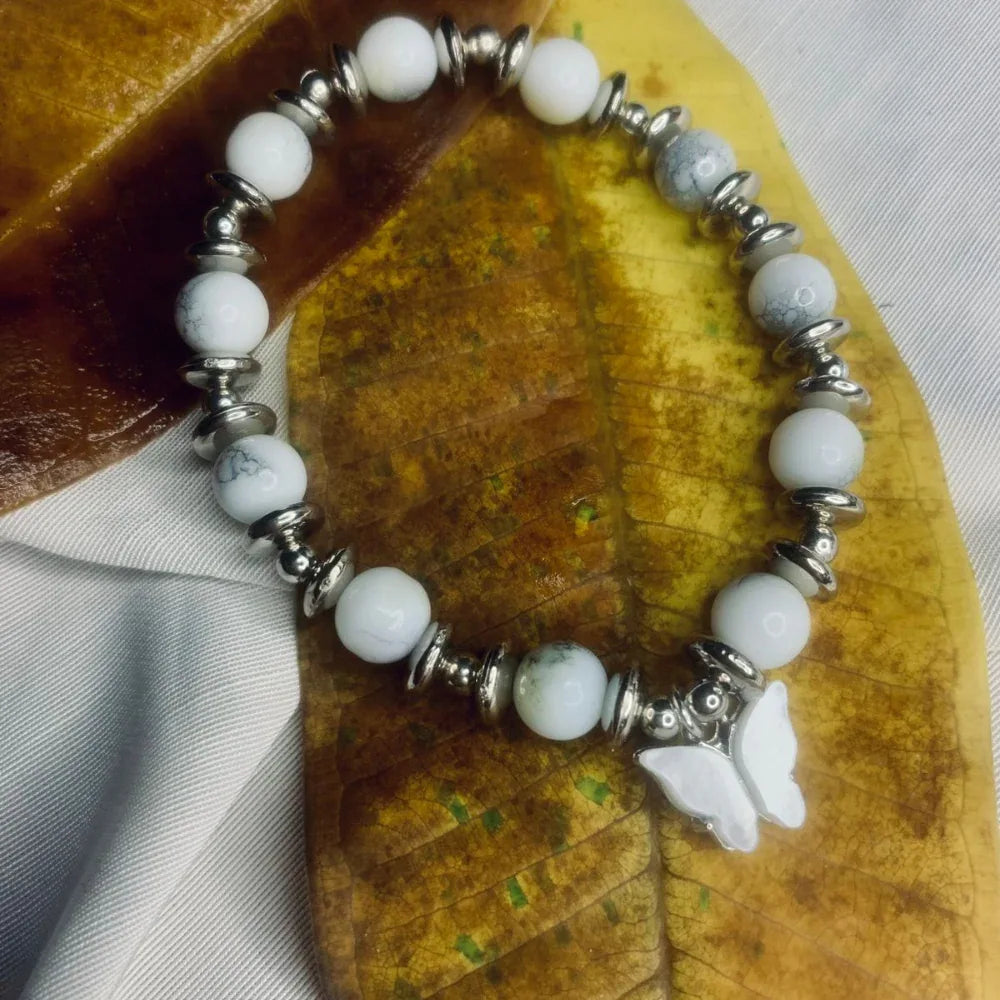 Dalmatian Jasper bracelet laid flat showing pattern of spotted stones and metallic silver accents