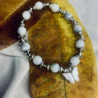 Dalmatian Jasper bracelet laid flat showing pattern of spotted stones and metallic silver accents