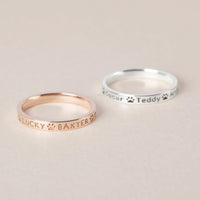 Close-up shot of a person wearing the custom pet names ring on their finger.