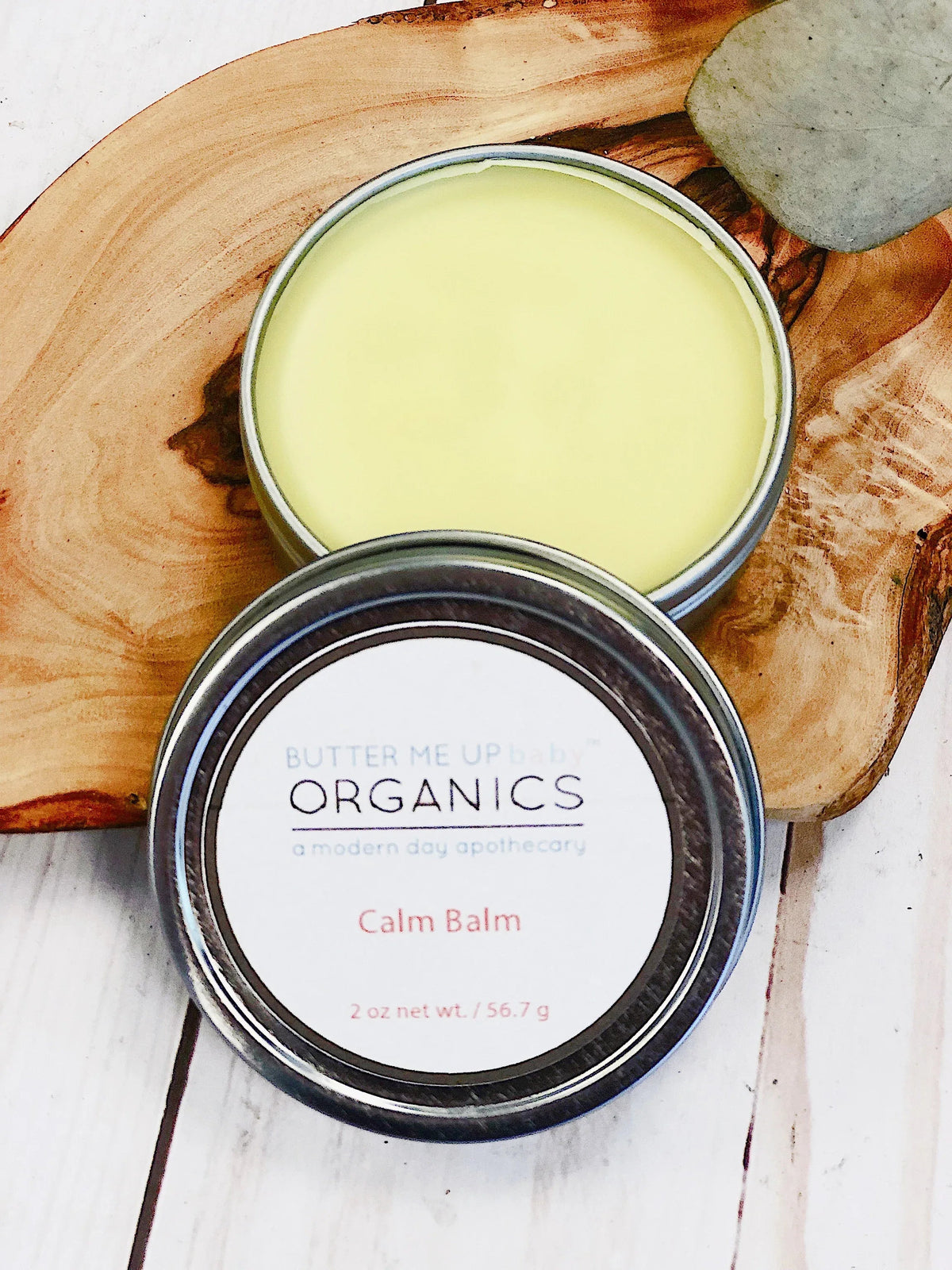 Jar of Calm Balm with lavender and chamomile ingredients on a light background, promoting relaxation.