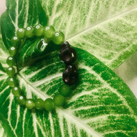 Handcrafted boho stretch bracelet made with natural green aventurine beads, shown in close view.