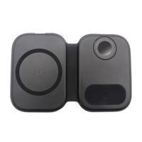 Magnetic folding 3-in-1 wireless charging station with smartphone on charging pad, placed on wooden surface.