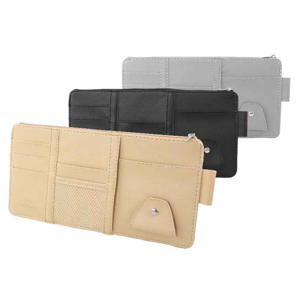 Black car sun visor organizer with multiple pockets holding cards, pen, and sunglasses inside a car