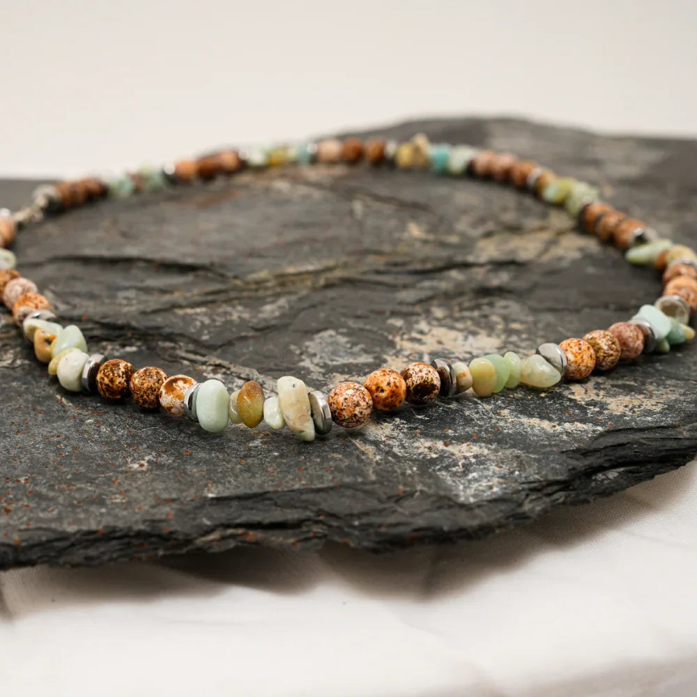 Multi-color natural agate stone necklace laid out to highlight varied bead shapes and colors.