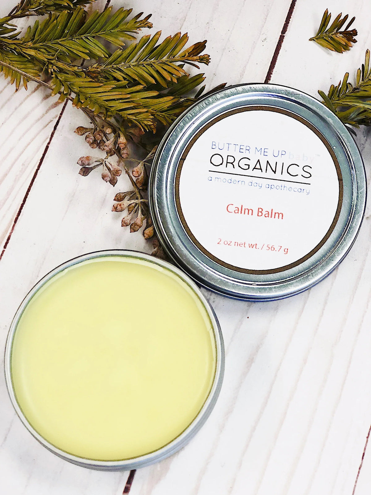 Close-up of Calm Balm container with product texture visible inside, suggesting soothing aromatherapy use.