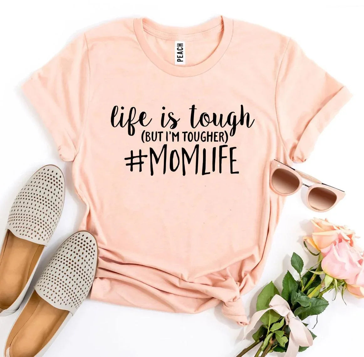 Back view of white #Momlife T-shirt on wooden surface