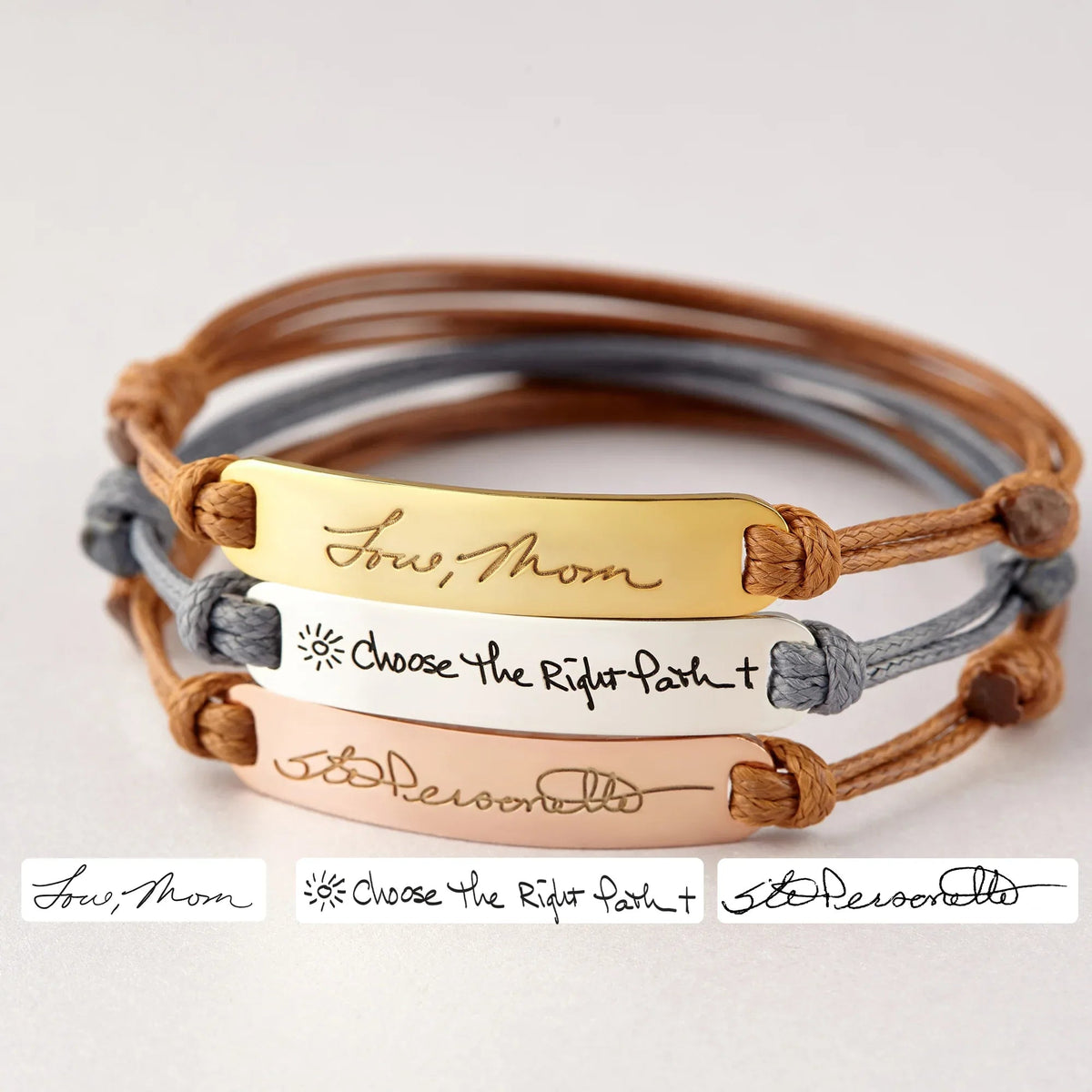 Close-up of a sterling silver bracelet engraved with personalized handwriting.