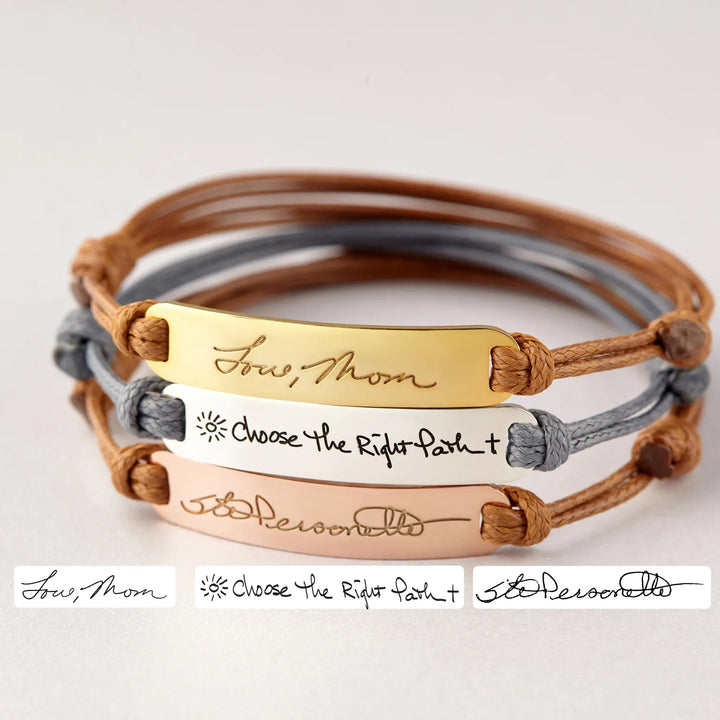 Close-up of a sterling silver bracelet engraved with personalized handwriting.