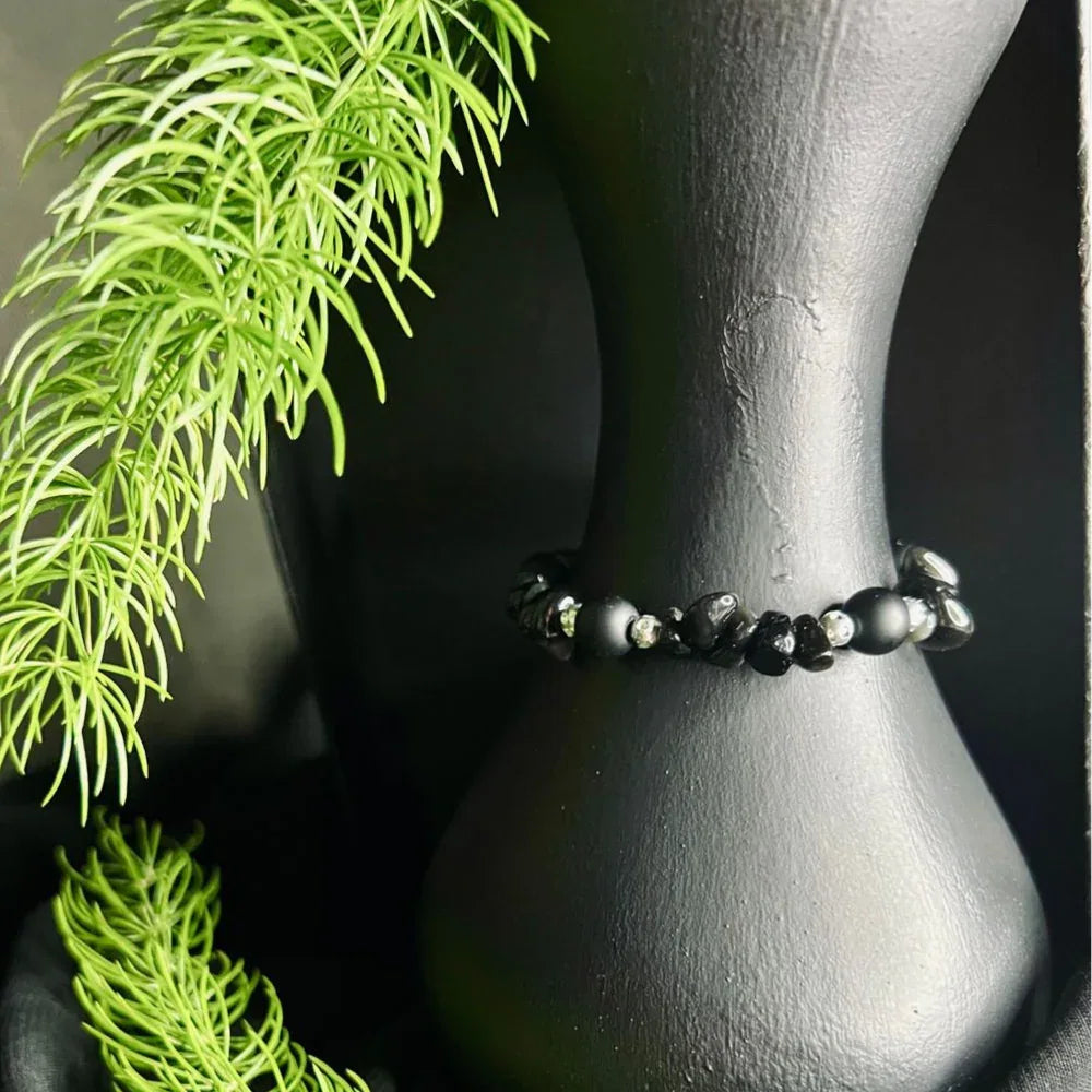 Boho style black stone chip bracelet shown coiled to display texture and shine.