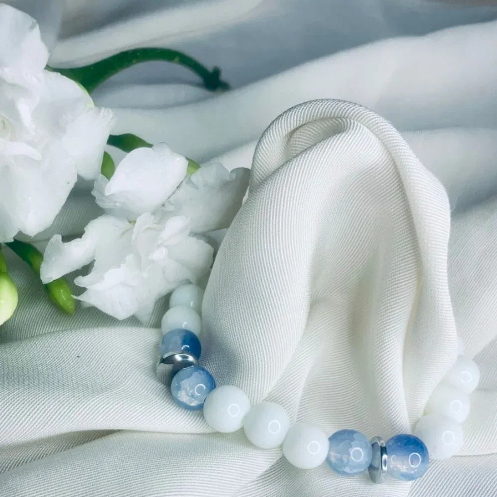 Blue lace agate and white howlite bracelet showcasing polished silver spacers in soft lighting.