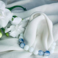 Blue lace agate and white howlite bracelet showcasing polished silver spacers in soft lighting.