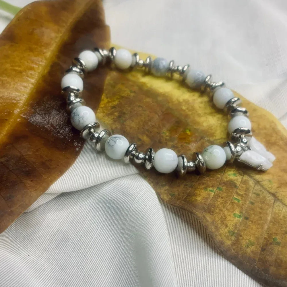 Side view of Dalmatian Jasper bracelet highlighting stretch band and silver spacer details