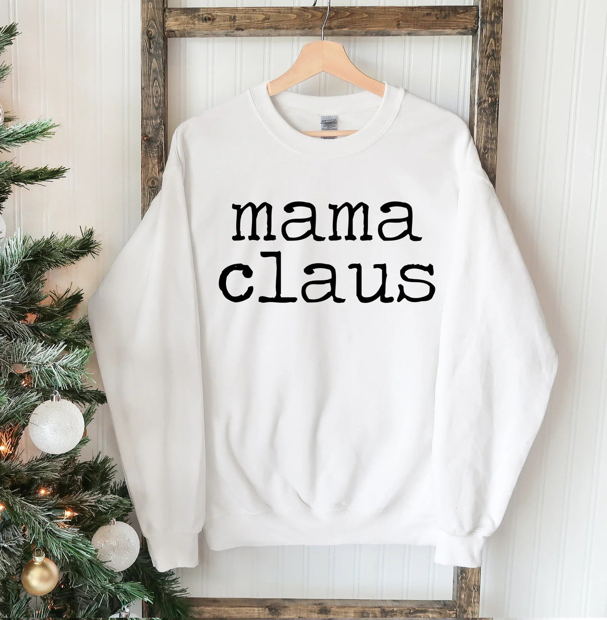 Model wearing Mama Claus Christmas sweatshirt, showing relaxed fit and crew neck collar.